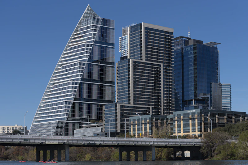 a very tall building sitting next to a body of water