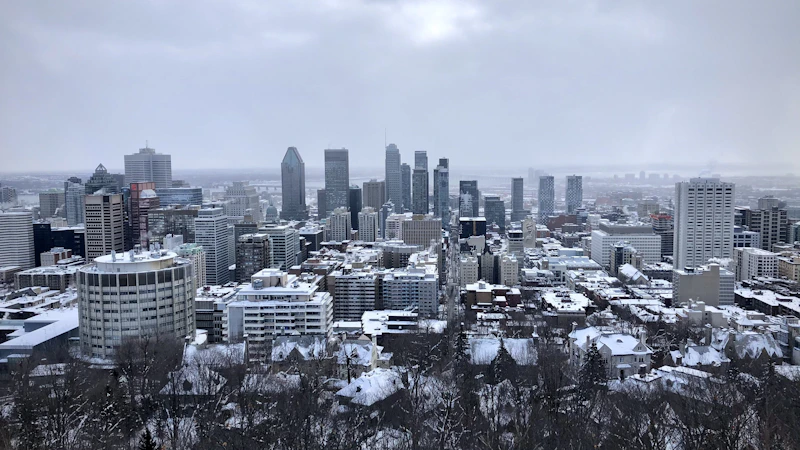 city skyline under gray cloudy sky during daytime