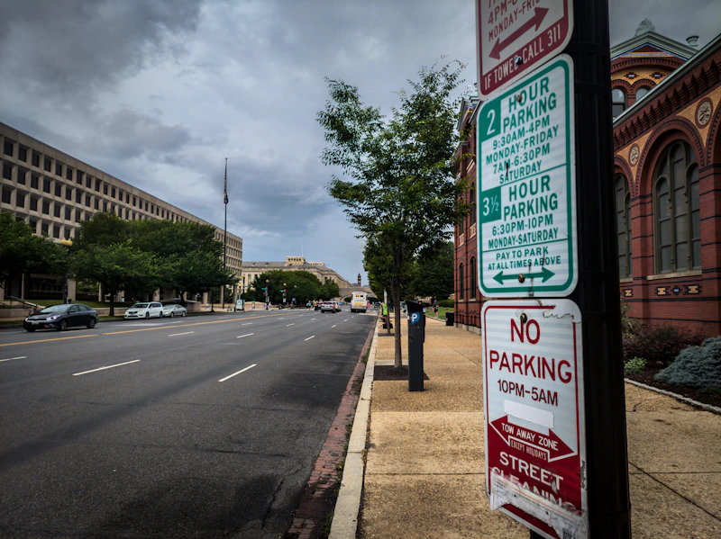 a no parking sign on the side of a road